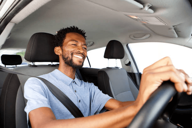 A Bolt driver smiling behind the wheel